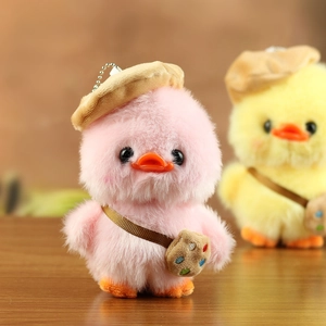 Detailed view of plush duck keychain featuring a brown beret and embroidered mini crossbody bag