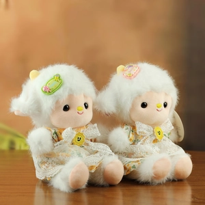 Detail of plush lamb dolls wearing yellow floral lace dresses and cute hair clips
