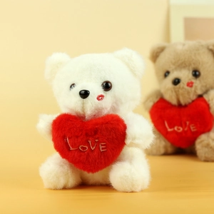 Detail of cute teddy bear plush with LOVE heart embroidery and red lip print