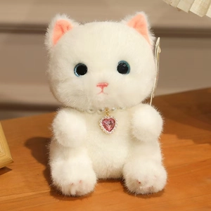 Close-up of cute white plush cat toy with pearl necklace and pink heart crystal pendant
