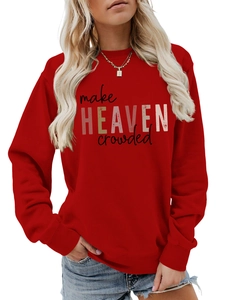 Close-up of red crewneck sweatshirt with make HEAVEN crowded artistic text and soft fabric