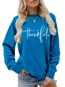 Detail of royal blue pullover sweatshirt featuring white Thankful script and ribbed neckline
