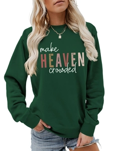 Detail of make heaven crowded art font on a dark green crewneck sweatshirt fabric
