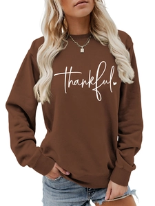 Detail of coffee brown sweatshirt featuring white thankful script and heart print