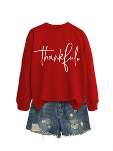 Detail view of red crewneck sweatshirt with white thankful script and heart print