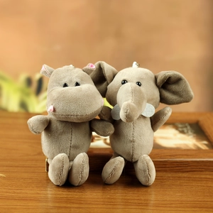 Plush elephant and hippo keychain charms in soft brown fabric on a wooden background