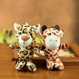 Close-up of plush leopard and giraffe hanging charms with metallic keyrings