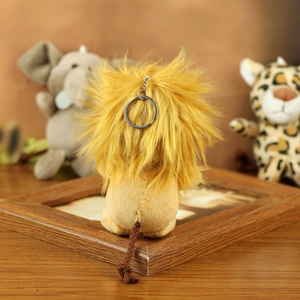 Rear view of plush lion keychain with fluffy yellow mane and brown woven rope tail