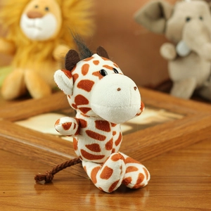 Close-up of a plush giraffe keychain with orange-brown spots and soft fabric texture