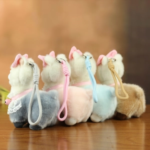 Detailed close-up of colorful alpaca plush keychains with lace collars and tiny bells