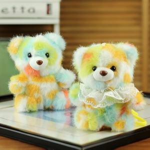 Close-up of colorful tie-dye plush teddy bear charms with soft fur and lace collar