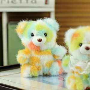 Macro detail of colorful tie-dye teddy bear plush showing soft long hair and texture