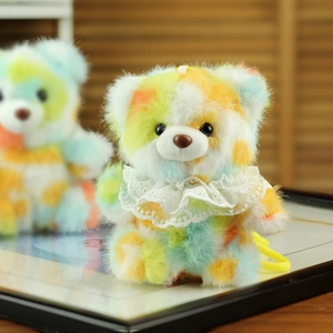 Detail of colorful plush bear keychain with lace collar and soft textured multi-color fur