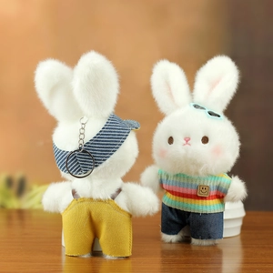 Detail of plush bunny charms in colorful knitted outfits and hats for bags