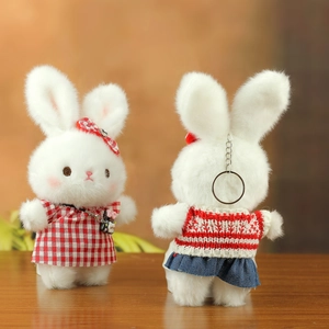 Detail of plush bunny keychains with red checkered dress and silver metal ring