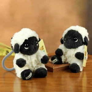 Cute black-faced sheep plush charm with soft white fur and a woven hanging strap