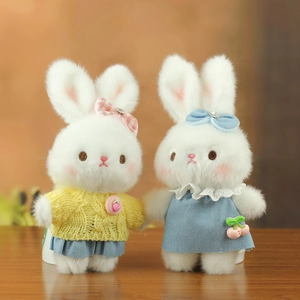 Detail of plush bunny charms in knit sweaters and lace dresses with cute fruit accessories