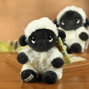 Detailed macro of a Valais Blacknose sheep plush with soft white fur and brand tag