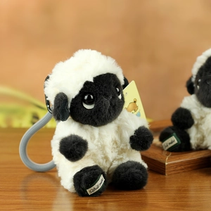 Detail of Valais Blacknose sheep plush keychain with branded Dolly tribe woven foot label