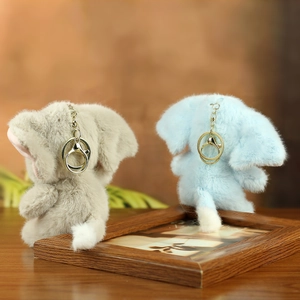 Detail of plush elephant keychains in grey and blue with premium golden metal rings