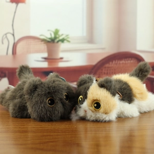 Close-up of plush cat toys featuring fluffy fur and large golden eyes on a wooden table