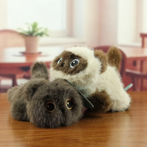 Macro detail of fluffy plush cat toy set in white and brown with long faux fur texture