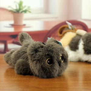 Macro detail of fluffy plush cat toy with large golden eyes on a warm wooden table