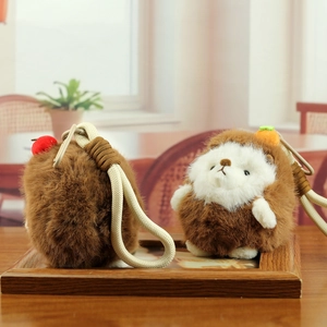 Detailed close-up of hedgehog plush charms with carrot and fruit decorations on wood