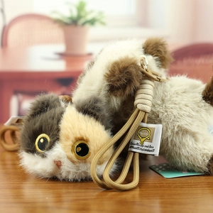 Macro detail of tricolor calico cat plush keychain with a thick woven lanyard
