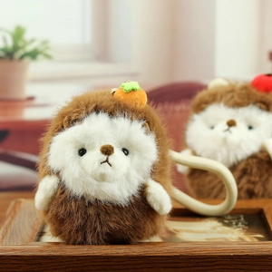 Detailed close-up of hedgehog plush keychain with orange fruit accessory and silicone strap