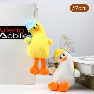 Detail shot of two 17cm plush duck keychains with colorful hats and small backpacks
