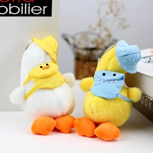 Cute plush duck keychains in white and yellow colors with tiny hats and backpacks