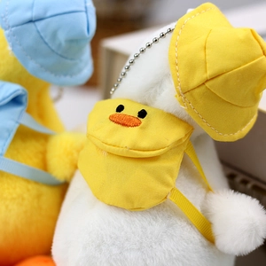 Close-up of cute plush duck keychains with colorful sun hats and miniature backpacks