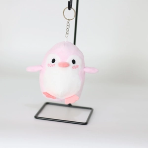 Detailed close-up of a pink penguin plush keychain with high-quality metal ring and soft fur