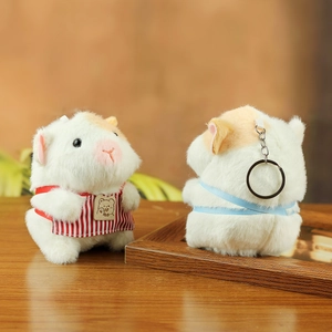 Detailed view of plush guinea pig keychain showing cute apron and metal ring clip
