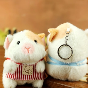 Detail of plush guinea pig keychains showing soft texture and cute striped apron