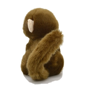 Back view of a cute dark brown plush monkey toy with a long tail and soft fluffy fur