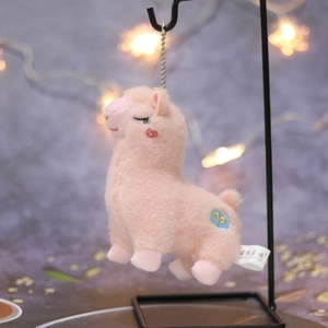 Cute pink alpaca plush keychain with golden constellation embroidery on metal stand