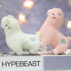 Cute alpaca plush keychains in beige and pink colors with soft fur and metal chains
