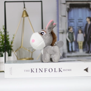 Detailed close-up of a cute gray plush donkey keychain with soft texture and mane