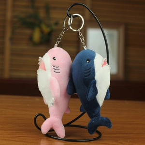 Detailed view of pink and blue plush shark pendants with quality stitching and metal rings