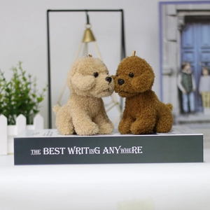 Cute teddy dog plush keychain toys in beige and brown shown on a decorative shelf