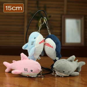 Plush shark keychains in four colors with 15cm height shown on a display stand