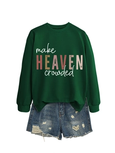 Flat lay of a green 'make HEAVEN crowded' sweatshirt with distressed blue denim shorts