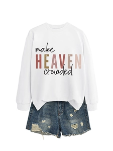 Flat lay of white long sleeve sweatshirt with 'Make Heaven Crowded' text and denim shorts
