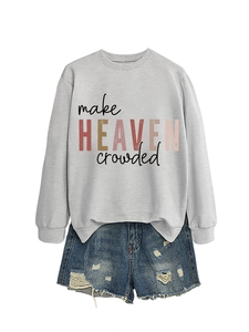 Flat lay of light grey sweatshirt with artistic text and distressed denim shorts