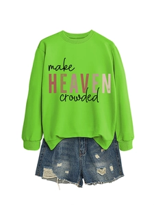 Detail of make heaven crowded lettering on green sweatshirt and distressed denim shorts