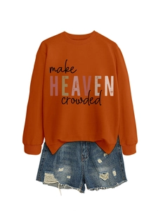 Detail of orange crewneck sweatshirt with 'make HEAVEN crowded' text print and side slit