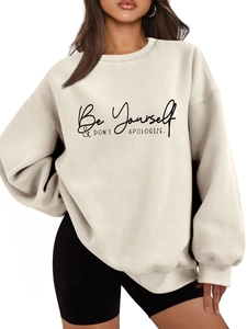 Detail of Be Yourself slogan print on cream thick oversized sweatshirt fabric