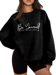Detail of white slogan print on black oversized crewneck sweatshirt for women